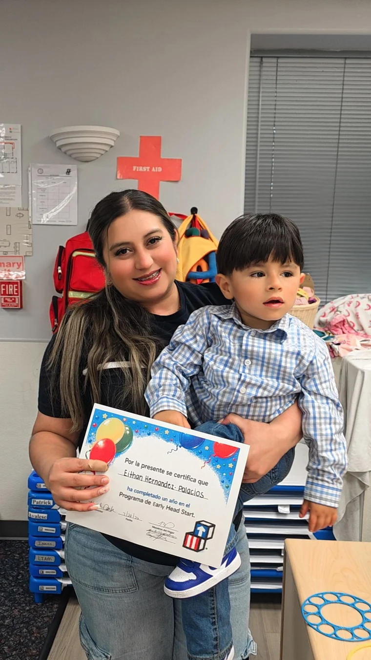 Delmy Palacios holding her son Eithan, who is holding his Early Head Start certificate
